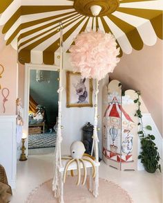 a canopy bed in the corner of a room with pink and gold decorations on it