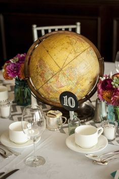 the table is set with plates, cups and silverware