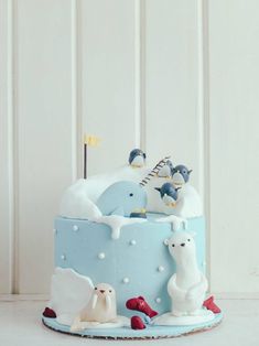 there is a blue cake with animals on it