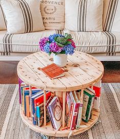 a coffee table with books on it in front of a couch