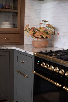 a kitchen with an oven, stove and cabinets in it's center island area