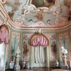 an elaborately decorated room with pink and blue walls