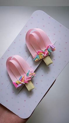 pair of pink and yellow flip flops with sprinkles on them sitting on top of a card