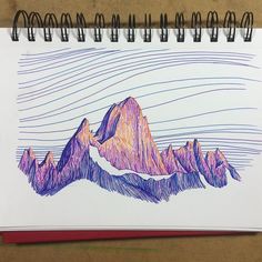 a drawing of mountains on a notepad