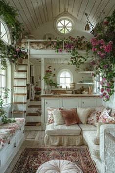 a living room filled with furniture and flowers on the wall next to a stair case