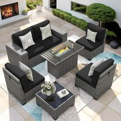 an outdoor living room with black and white furniture