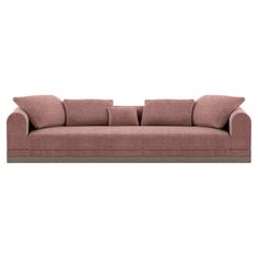 a pink couch with four pillows on it's back and one arm folded up