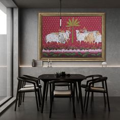 a painting hanging on the wall above a table with four chairs and a small potted plant