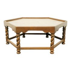 an octagonal wooden table with white marble top