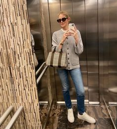 a woman taking a selfie in an elevator