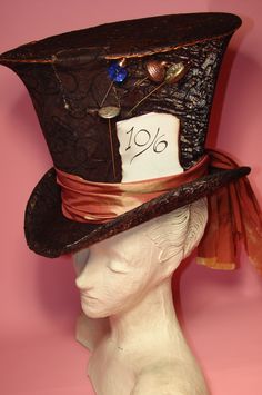 a white mannequin head wearing a brown hat with a price tag on it