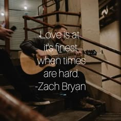 a man sitting on the steps playing an acoustic guitar with a quote from zach blyan