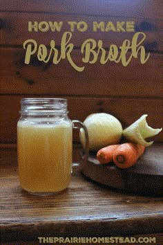 a jar filled with liquid sitting on top of a wooden table next to some vegetables