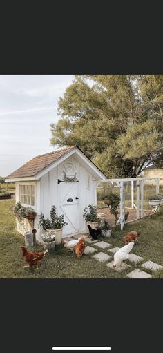 a chicken coop with chickens in the yard