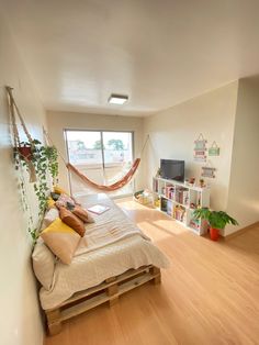 a bedroom with a hammock hanging from the ceiling