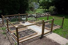 an outdoor garden area with raised beds and plants