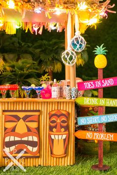 a tiki bar with lots of signs on it