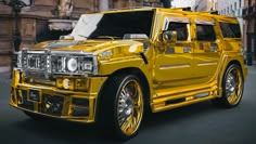 a yellow hummer truck is parked on the street