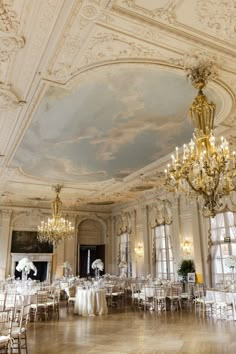 an elegant ballroom with chandeliers and tables