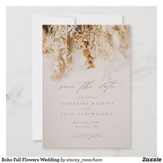 a white wedding card with gold foil flowers