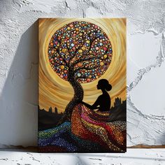 a painting of a woman sitting in front of a tree with colorful stones on it