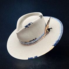 Fedora Hat This stylish fedora features a 4 1/2" crown and a 3 3/4" brim, perfect for adding a touch of sophistication to your look. Adorned with unique feather blue patchwork and a matching band, it offers a distinctive and eye-catching appeal. Head circumference size: Adjustable L (21.7 - 22.4 inches / 55 - 57 cm) Crown depth: 4.7 inches / 12 cm Brim width: 3.1 inches / 8 cm Luxury Handmade Leather Hat Bands, Luxury Leather Hat Bands With Curved Brim, Luxury Adjustable Hat Bands With Feathers, Luxury Adjustable Blue Hat Bands, Cowboy Hat Styles, Mens Dress Hats, Tuxedo Accessories, Pork Pie Hat, City Slickers