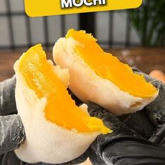 a person is peeling an orange peel with their gloved hand and the words mochi written above it