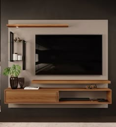 a flat screen tv mounted to the side of a wooden entertainment center in a living room