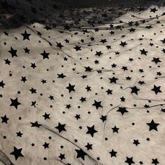 black and white stars are scattered all over the ground