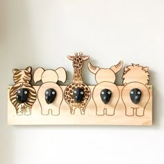 a group of wooden animals hanging on a wall