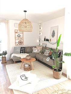 a living room filled with lots of furniture and decor on top of a hard wood floor