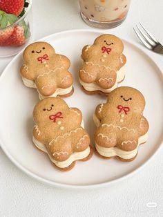 some cookies are on a white plate with strawberries