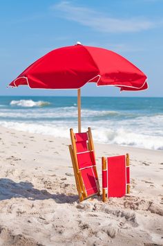 an umbrella and two chairs on the beach