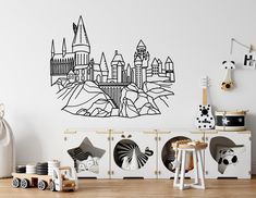 a child's room with a wall decal that has a castle on it