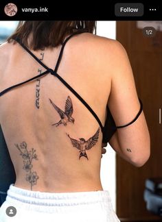 the back of a woman's body with tattoos on her upper and lower back