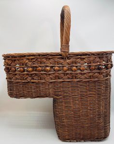 a brown wicker basket with wooden handles