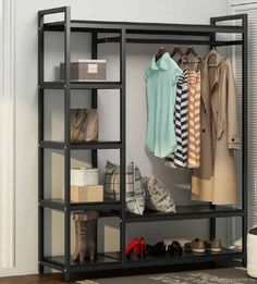 an open closet with shoes and clothing hanging on the rack, next to a door