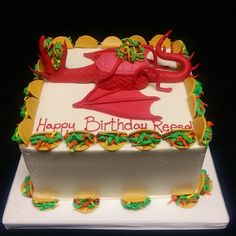 a birthday cake with an image of a dragon on it