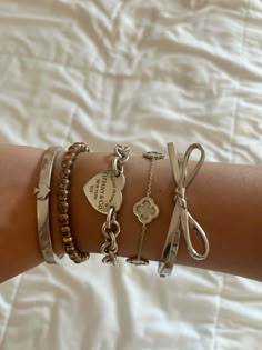 Jewellery For School, Tiffany And Co Bracelet Silver, Tiffany Stacked Bracelets, Kate Spade Bracelet Stack, Gold And Silver Jewelry Stack, Tiffany And Co Jewelry Aesthetic, Tiffany Bracelet Aesthetic, Tiffany And Co Bracelet Stack, Tiffany Necklace Stack