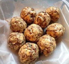 a bunch of cookies sitting on top of a white paper bag filled with chocolate chip muffins