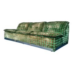 a green couch sitting on top of a white floor