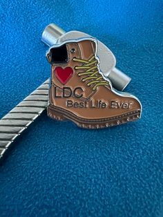 a metal keychain with a shoe on it that says, best life ever