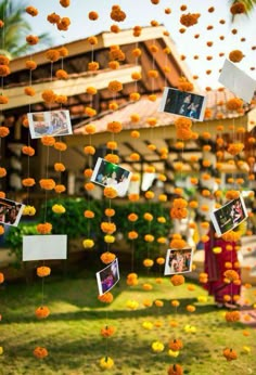 an outdoor area with flowers and pictures hanging from it's ceiling, in the middle of