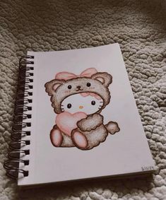 a drawing of a teddy bear with a pink bow on it's head sitting on a bed