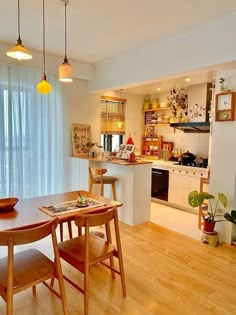 a dining room table and chairs in front of a window