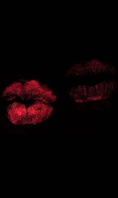 two red lips are lit up in the dark