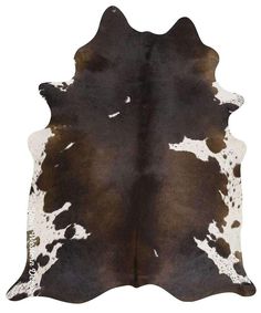 a brown and white cowhide rug on a white background