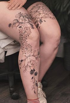 a woman's legs with flowers on them