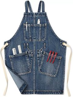 a denim apron with scissors and other items in the pocket, on a white background