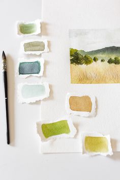 some watercolor paints are sitting on a table